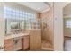 This bathroom boasts a modern shower with glass block accents, perfect for relaxation and style at 3073 Gulf Winds Cir, Hernando Beach, FL 34607