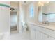 Elegant bathroom features a shower-tub combo, marble counters, and white cabinets at 3073 Gulf Winds Cir, Hernando Beach, FL 34607