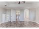 This bedroom features an open layout, neutral paint, ceiling fan, and tile flooring for comfort at 3073 Gulf Winds Cir, Hernando Beach, FL 34607