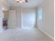 Bedroom features soft carpet, ceiling fan, and doorways to other rooms at 3073 Gulf Winds Cir, Hernando Beach, FL 34607