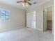 Light-filled bedroom with soft carpet, large window, and ensuite bathroom at 3073 Gulf Winds Cir, Hernando Beach, FL 34607