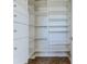 Open closet with custom white shelving and drawers for organized storage at 3073 Gulf Winds Cir, Hernando Beach, FL 34607