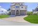 Beautiful three-story home with a two-car garage, arched entryway, and well-manicured lawn at 3073 Gulf Winds Cir, Hernando Beach, FL 34607