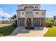 Exterior elevation of home with attached garages, landscaped yard and neutral paint scheme at 3073 Gulf Winds Cir, Hernando Beach, FL 34607