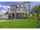 Three-story home with well-maintained lawn and landscaping, providing a welcoming curb appeal at 3073 Gulf Winds Cir, Hernando Beach, FL 34607