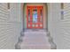 Elegant front entrance with a colorful door, textured brick and inviting steps at 3073 Gulf Winds Cir, Hernando Beach, FL 34607