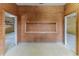 Unfinished interior with wood walls, tile floors, and open doorways offers customization at 3073 Gulf Winds Cir, Hernando Beach, FL 34607