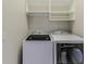 Laundry room with washer, dryer, and storage shelves at 3073 Gulf Winds Cir, Hernando Beach, FL 34607