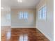 Bright living room features hardwood floors and large windows at 3073 Gulf Winds Cir, Hernando Beach, FL 34607