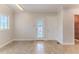Bright living room boasts large windows and neutral tile flooring for a versatile space at 3073 Gulf Winds Cir, Hernando Beach, FL 34607