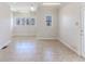 Bright living room boasts large windows and neutral tile flooring for a versatile space at 3073 Gulf Winds Cir, Hernando Beach, FL 34607