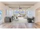 Inviting living room featuring hardwood floors, bright windows, a ceiling fan and stylish furniture at 3073 Gulf Winds Cir, Hernando Beach, FL 34607