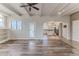 Spacious living room open to the kitchen with windows and an exterior door at 3073 Gulf Winds Cir, Hernando Beach, FL 34607
