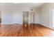 Spacious room featuring hardwood floors, with hallway and staircase access at 3073 Gulf Winds Cir, Hernando Beach, FL 34607