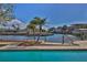 Beautiful view from the pool overlooks the canal, showcasing the waterfront lifestyle at 3073 Gulf Winds Cir, Hernando Beach, FL 34607