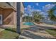 Relax in the pool, surrounded by palm trees and offering serene water views at 3073 Gulf Winds Cir, Hernando Beach, FL 34607