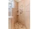 This walk-in shower features neutral tile, multiple shower heads and built-in shelving at 3073 Gulf Winds Cir, Hernando Beach, FL 34607
