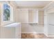 Walk-in closet with custom shelving, drawers, and a window providing natural light at 3073 Gulf Winds Cir, Hernando Beach, FL 34607