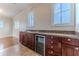 Cozy wet bar boasts wood cabinetry, granite counters, wine storage and arched windows at 3073 Gulf Winds Cir, Hernando Beach, FL 34607