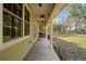 Back porch with ceiling fans, overlooking a spacious yard at 33501 Prospect Rd, Dade City, FL 33525