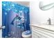 Bright bathroom featuring a dolphin-themed shower curtain and a sleek white vanity at 3542 Connon Dr, New Port Richey, FL 34652