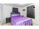 Cozy bedroom with a comfortable bed, soft purple bedding, and black bedside tables at 3542 Connon Dr, New Port Richey, FL 34652