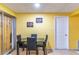 Bright dining area featuring tiled floors, a ceiling fan, and an elegant black table at 3542 Connon Dr, New Port Richey, FL 34652