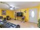 Bright living room featuring tiled floors, a ceiling fan, and a comfortable leather sofa at 3542 Connon Dr, New Port Richey, FL 34652
