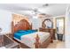 Spacious main bedroom showcasing an ornate wooden bed frame, dresser, and ceiling fan at 3542 Connon Dr, New Port Richey, FL 34652