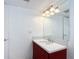 Bathroom with a dark red vanity and a large mirror at 3640 Richboro Dr, Holiday, FL 34691