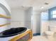 Modern bathroom featuring a soaking tub, a tiled shower, and decorative shelving at 3640 Richboro Dr, Holiday, FL 34691