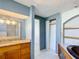 Bathroom featuring a wooden vanity with granite counters, and a separate sink area at 3640 Richboro Dr, Holiday, FL 34691
