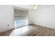 Bedroom with a large window and wood-look flooring at 3640 Richboro Dr, Holiday, FL 34691