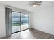 Bedroom with sliding glass doors leading to the fenced backyard at 3640 Richboro Dr, Holiday, FL 34691