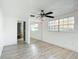 Bright bedroom with wood-look flooring, closet with mirrored sliding doors, and lots of natural light at 3640 Richboro Dr, Holiday, FL 34691