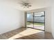 Bright bedroom with sliding glass doors leading to the fenced backyard at 3640 Richboro Dr, Holiday, FL 34691