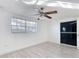 Bedroom featuring wood-look flooring, a ceiling fan, and a window with blinds at 3640 Richboro Dr, Holiday, FL 34691