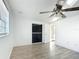 Bedroom featuring wood-look flooring, ceiling fan, and ample closet space at 3640 Richboro Dr, Holiday, FL 34691