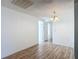 Dining room featuring wood-look flooring, a chandelier, and access to other rooms at 3640 Richboro Dr, Holiday, FL 34691
