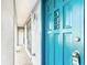 Close up of a vibrant blue front door with glass accents and a tiled porch entryway at 3640 Richboro Dr, Holiday, FL 34691