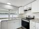 A well-equipped kitchen showcasing stainless steel appliances and a white subway tile backsplash at 3640 Richboro Dr, Holiday, FL 34691