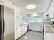 Modern kitchen with stainless steel appliances, granite counters, and white cabinets at 3640 Richboro Dr, Holiday, FL 34691
