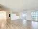 Bright, airy living room with wood-look flooring and updated windows provides lots of natural light at 3640 Richboro Dr, Holiday, FL 34691