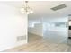 Open floor plan with living and kitchen areas, wood-look floors, and neutral paint at 3640 Richboro Dr, Holiday, FL 34691
