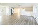 Open concept living room with wood-look flooring, ceiling fan, and access to the kitchen area at 3640 Richboro Dr, Holiday, FL 34691