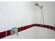Shower with white tiles and maroon accents at 3640 Richboro Dr, Holiday, FL 34691