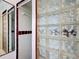 Tiled shower with glass block, with maroon accents at 3640 Richboro Dr, Holiday, FL 34691