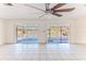 Bright living room featuring tile floors, ceiling fan, and sliding glass doors to the waterfront at 4258 Camelia Dr, Hernando Beach, FL 34607