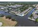 Aerial view of waterfront condos in a community with tree coverage, pool, and boat docks at 432 Moorings Cove Dr. # 432, Tarpon Springs, FL 34689