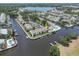 Aerial view of waterfront condos with docks, boats, and a community pool by the river at 432 Moorings Cove Dr. # 432, Tarpon Springs, FL 34689